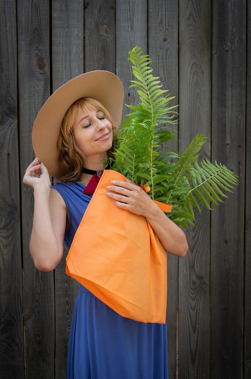 portrait, nature, woman, fern, a bag, person, fence, boards, hat, summer, florist, plants, people, young woman, cheerful, smile, positive, happiness, joy
